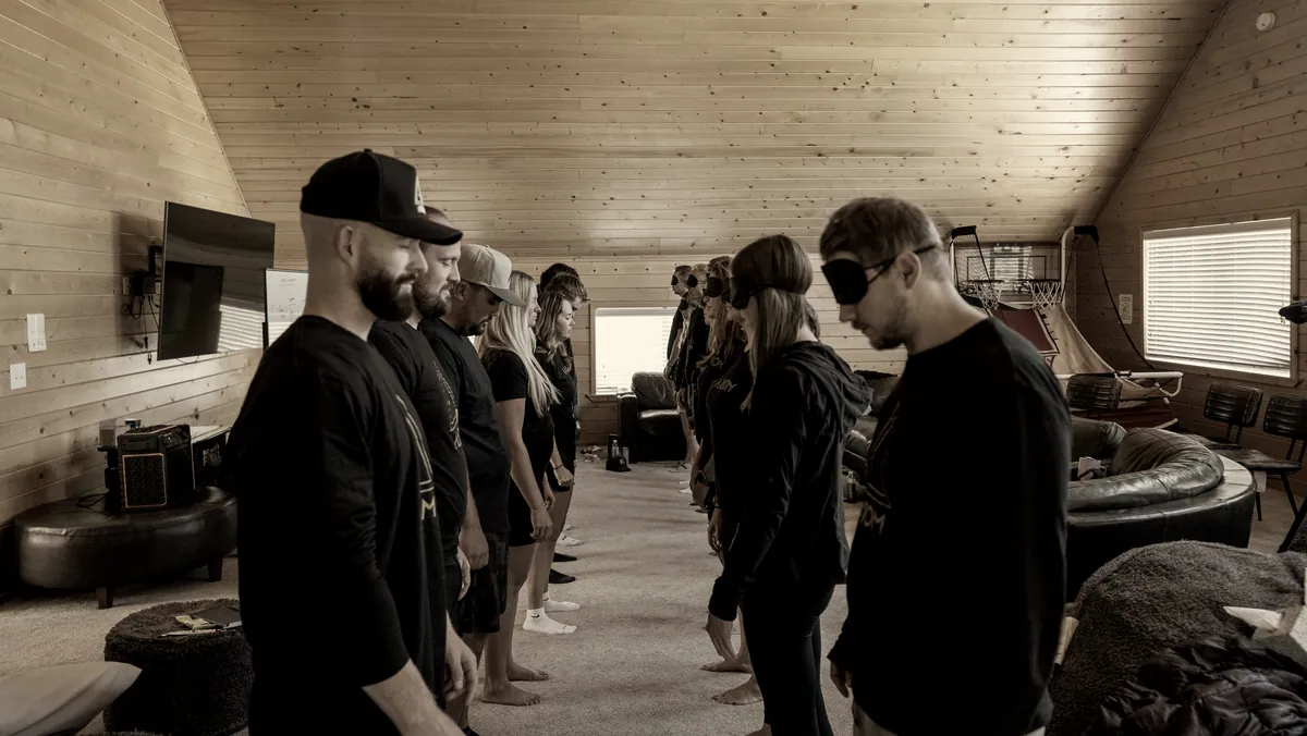 Participants practicing perception together in a wood-paneled training room.